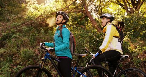 Young Women Enjoying Mountain Biking Adventure in Forest - Download Free Stock Images Pikwizard.com