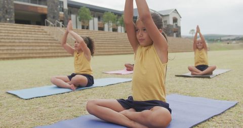 Diverse Girls Practicing Yoga in School Yard
