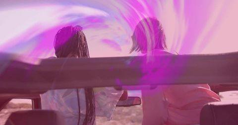 Friends Enjoying Sunset Glow During Road Trip Adventure