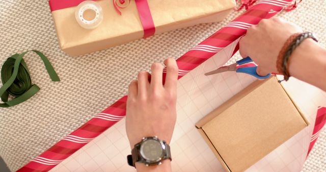 Person Wrapping Christmas Presents with Red Ribbon and Craft Paper - Download Free Stock Images Pikwizard.com