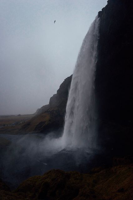 Majestic Waterfall Cascading Down Cliffs at Dusk - Download Free Stock Images Pikwizard.com