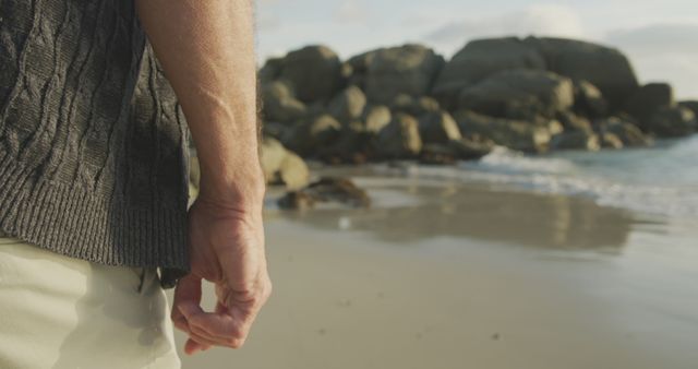 Senior Man's Hand on Serene Ocean Beachside - Download Free Stock Images Pikwizard.com