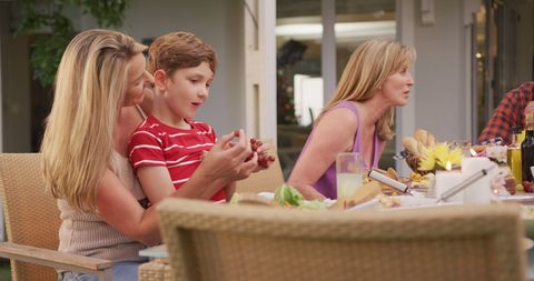 Family Enjoying Outdoor Dinner with Laughter and Togetherness - Download Free Stock Images Pikwizard.com