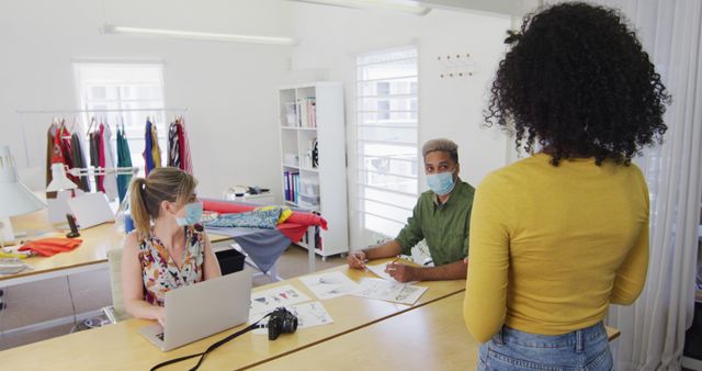 Fashion Designers Collaborating in Studio While Wearing Face Masks - Download Free Stock Images Pikwizard.com