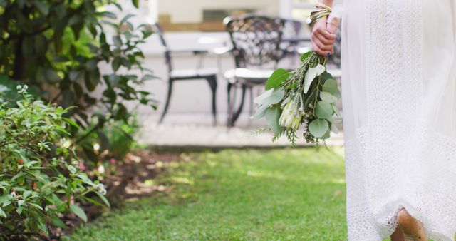 Woman in White Dress Holding Bouquet in Garden - Download Free Stock Images Pikwizard.com