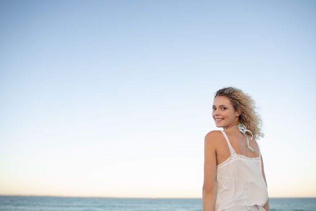 Portrait of beautiful woman standing on the beach 