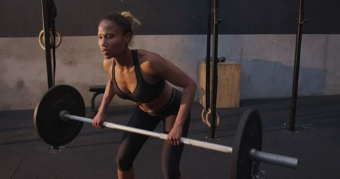 Focused Athlete Lifting Barbell at Gym Workout