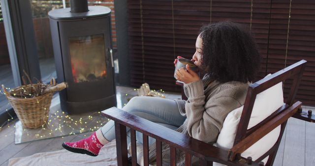 Woman Relaxing with Hot Drink by Fireplace in Cozy Home - Download Free Stock Images Pikwizard.com