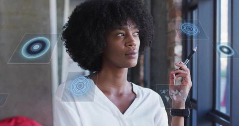 Businesswoman Innovating with Futuristic Holographic Panels in Modern Workspace