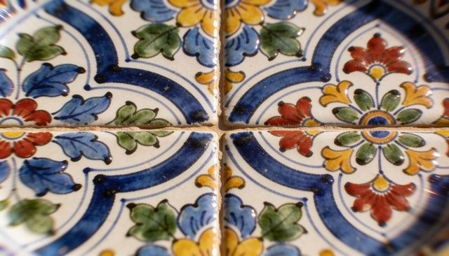 Hand-painted ceramic tile mosaic featuring floral blue red yellow pattern