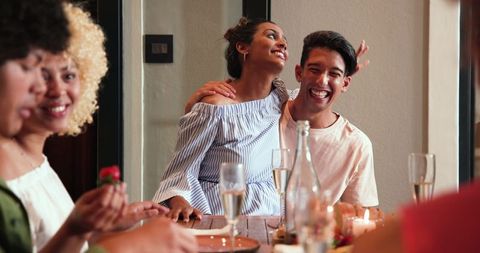 Diverse Friends Celebrating with Dinner and Champagne