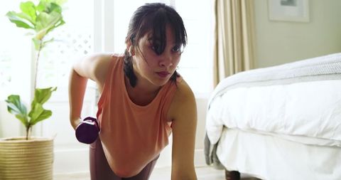 Asian Woman Performing Strength Exercise with Dumbbell at Home