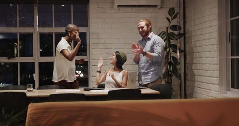 Diverse Team Collaborating for Nighttime Office Project