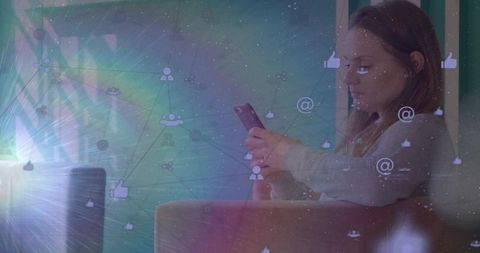 Woman scrolling smartphone on couch with social media network overlay and sun flare