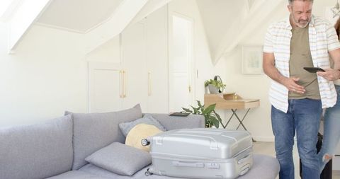 Mature couple preparing for travel at home