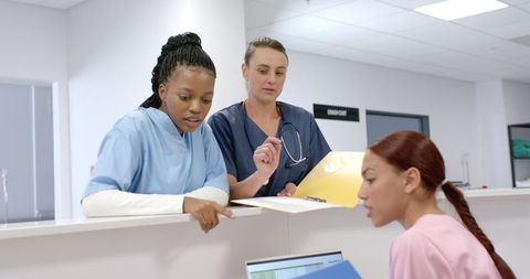 Healthcare Professionals Reviewing Documents in Hospital Setting