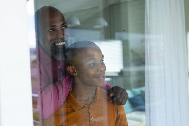 Senior African American Man with Son Looking Out Window - Download Free Stock Images Pikwizard.com