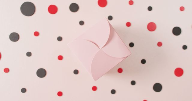 Elegant Pink Gift Box Surrounded by Black and Red Confetti on Light Background - Download Free Stock Images Pikwizard.com