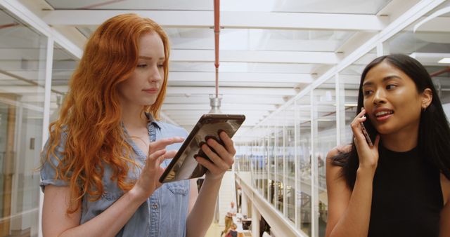 Young Women Using Tablet and Talking on Phone in Modern Office - Download Free Stock Images Pikwizard.com