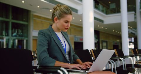 Focused Businesswoman Working on Laptop in Modern Conference Room