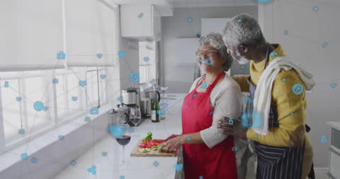 Senior Couple Enjoying Cooking Together Amidst Virtual Connections