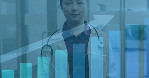 Asian Doctor with Financial Graphs Reflected in Hospital