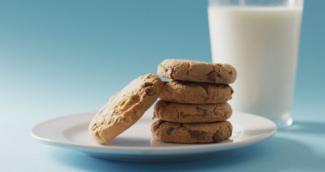 Image of biscuits with chocolate and milk on blue background. cookies,bake, food, candy, snacks and sweets concept.
