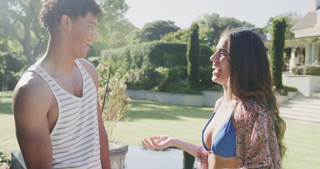 Young couple smiling and talking in sunny backyard - Download Free Stock Images Pikwizard.com