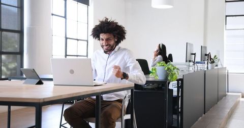 Joyful Businessman Celebrating Success in Modern Office