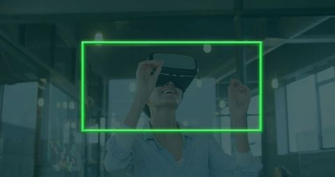 Woman using vr headset in modern office with neon frame