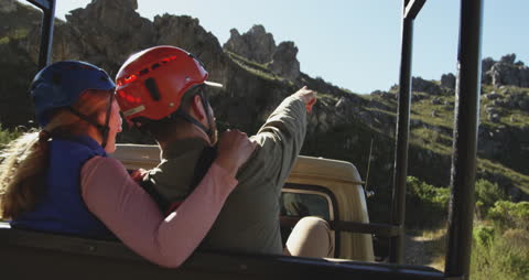 Couple Embracing Adventure in Mountainous Ziplining Expedition