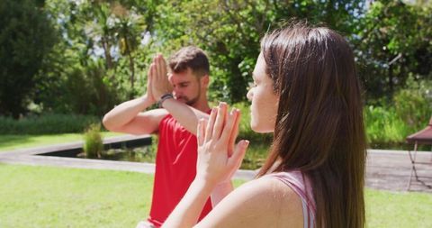 Couple Practicing Mindful Yoga Outdoors in Tranquil Park