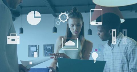 Female pointing at laptop collaborating with team in modern coworking space cloud icons