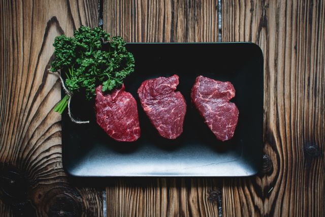 This image is perfect for food blogs, recipe websites, culinary magazines, or restaurant menus emphasizing freshness and premium cuts of meat. It can also be used in advertisements for beef products, butcher shops, or cooking classes aimed at meat preparation techniques.