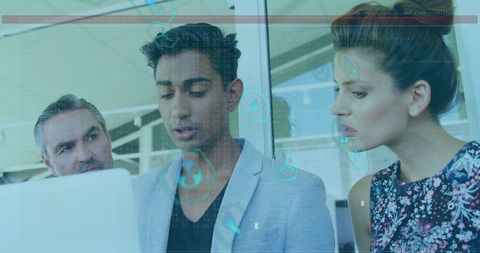 Innovative team reviewing data on laptop in modern office