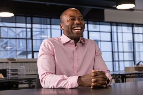Smiling Professional Seated at Office Table for Team Meeting