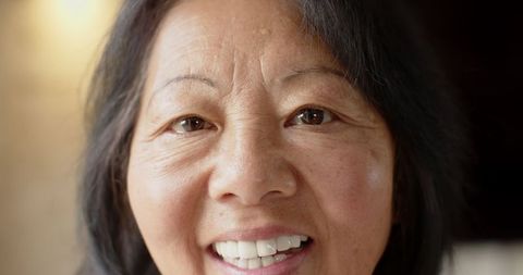 Elderly Asian Woman Smiling with Warm Authenticity