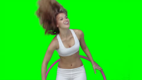 Woman Using Hula Hoop Against Green Background