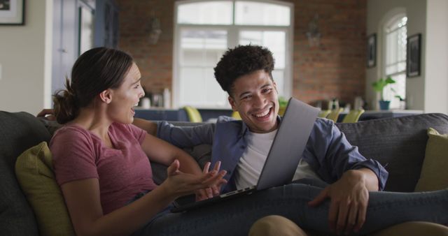 Couple Relaxing at Home Laughing While Using Laptop - Download Free Stock Images Pikwizard.com