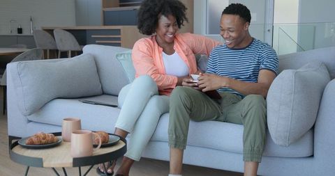 Cheerful Young Couple Relaxing at Home Together