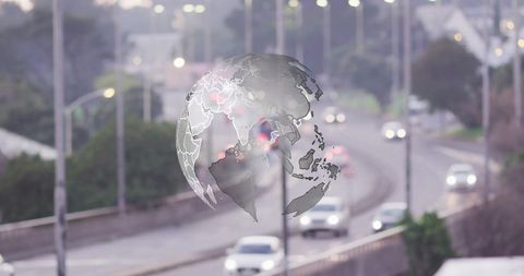 Transparent Globe Overlays Busy Urban Highway Setting