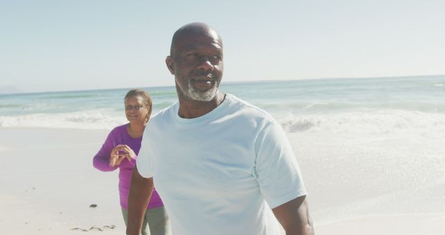 Senior Couple Enjoying a Walk on the Beach - Download Free Stock Images Pikwizard.com