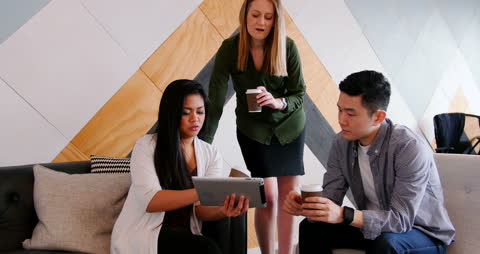 Diverse Team Collaborating with Digital Devices in Modern Workplace