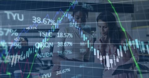 Women analyzing financial charts in modern office environment