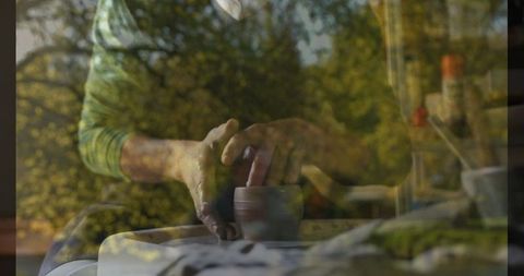 Double exposure art: potter crafting clay cup with natural foliage overlay