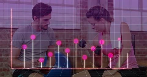 Fitness trainer coaching trainee using tablet while trainee curls dumbbell with live data overlay