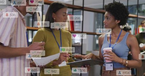Young professionals reviewing documents discussing social media metrics in modern office