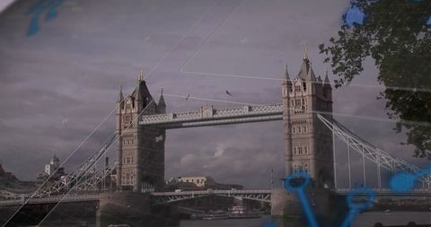 Tower bridge with digital icons and boats on river thames