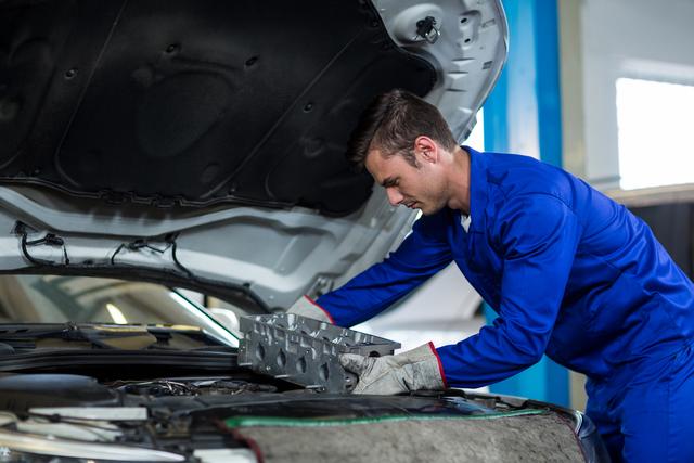 Mechanic installing car parts - Download Free Stock Photos Pikwizard.com