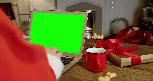 Person in Santa Suit Using Laptop with Green Screen in Festive Home - Download Free Stock Images Pikwizard.com